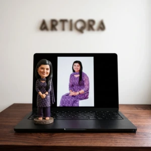 Our Work 22 Custom chibi-style 3D portrait of an Indian woman wearing a purple traditional outfit, handcrafted by Artiqra.