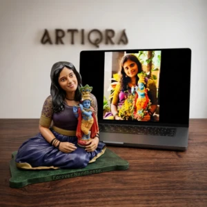 Our Work 51 Custom hand-painted sculpture of a seated woman holding a Lord Krishna idol, recreated from her personal photograph by Artiqra.